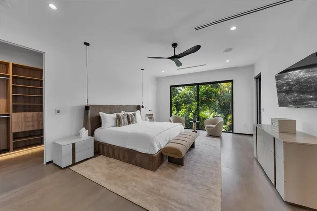 a front view of a house with a garden and a tree