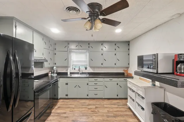 a view of kitchen with furniture and a refrigerator