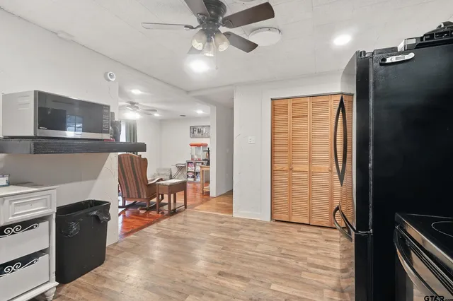 a kitchen with granite countertop a refrigerator stove and sink