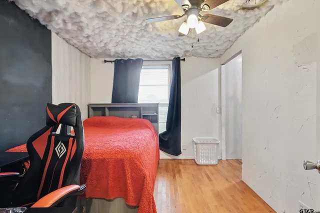 a bed room with a bed and a chandelier