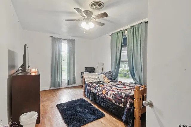 a bedroom with a bed and a chandelier
