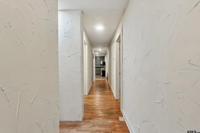 a kitchen with granite countertop a refrigerator stove top oven and sink