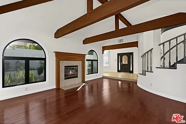a view of an entryway with wooden floor fireplace