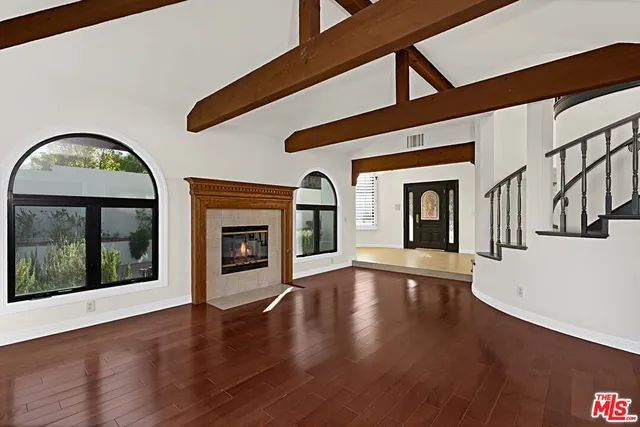a view of an entryway with wooden floor fireplace