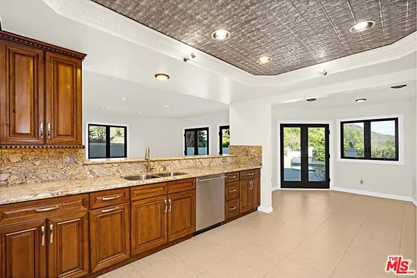 a large white kitchen with a large window