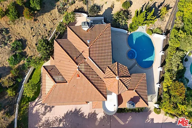 an aerial view of a house with entertaining space