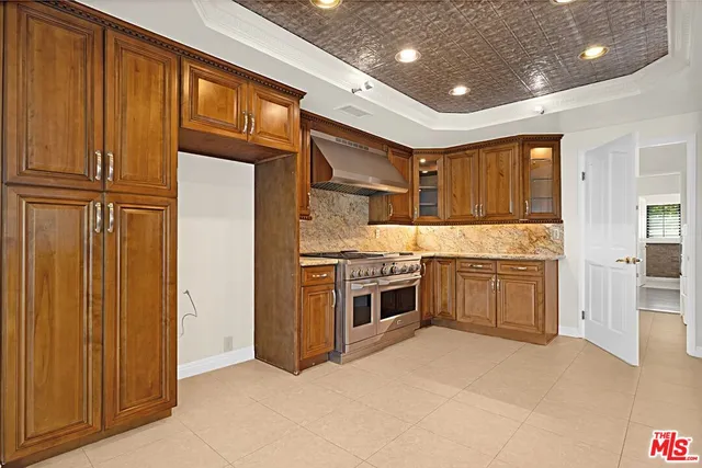 a kitchen with granite countertop a sink stainless steel appliances and cabinets