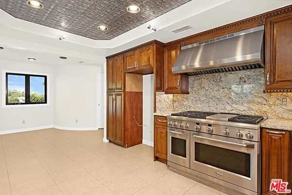 a kitchen with a stove and a refrigerator