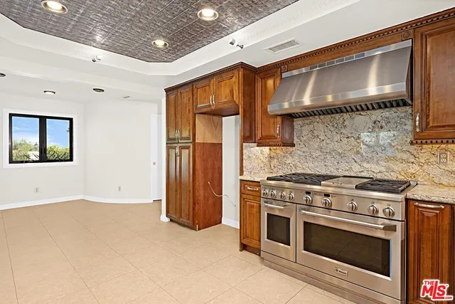 a kitchen with a stove and a refrigerator