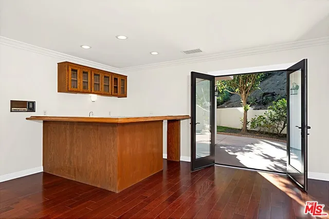 a view of a living room hardwood floor and a large window