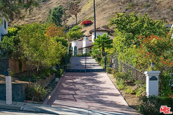 a view of a pathway of a house with a yard