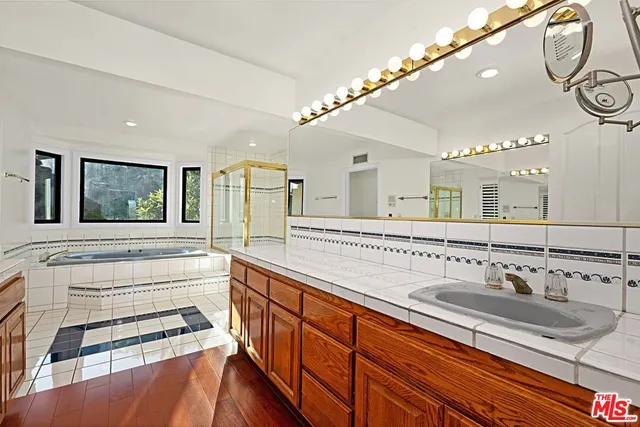 a bathroom with a sink a mirror and a window