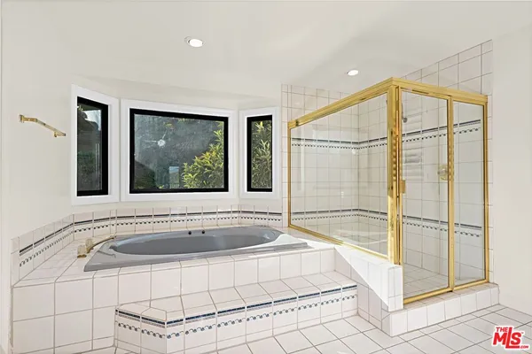 a bathroom with a bathtub and shower