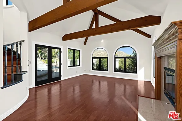 a view of an entryway with wooden floor and windows