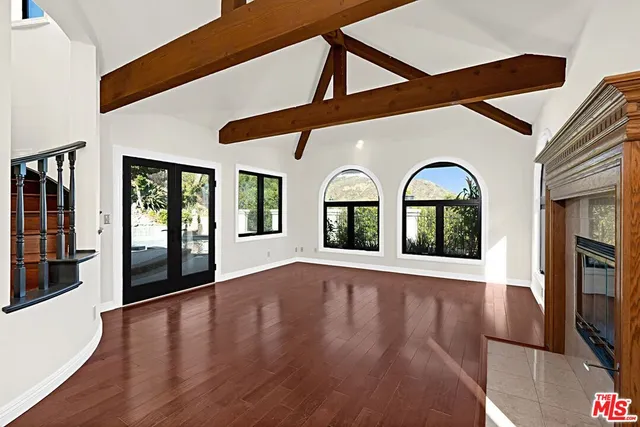 a view of an entryway with wooden floor and windows