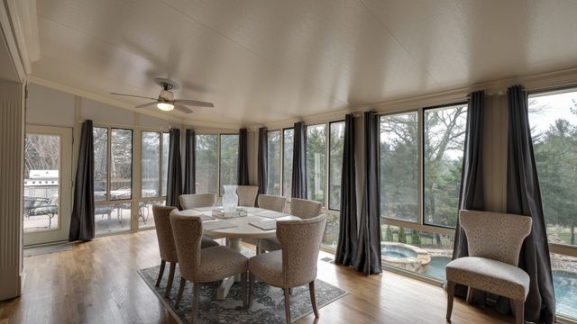 a bedroom with a large bed and a flat tv screen on dresser