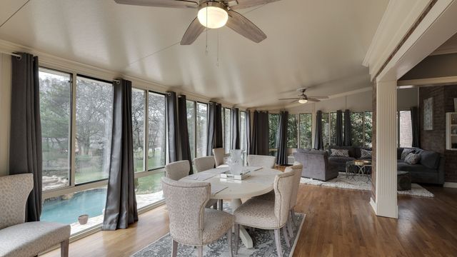 a bedroom with a large bed and a flat tv screen on dresser