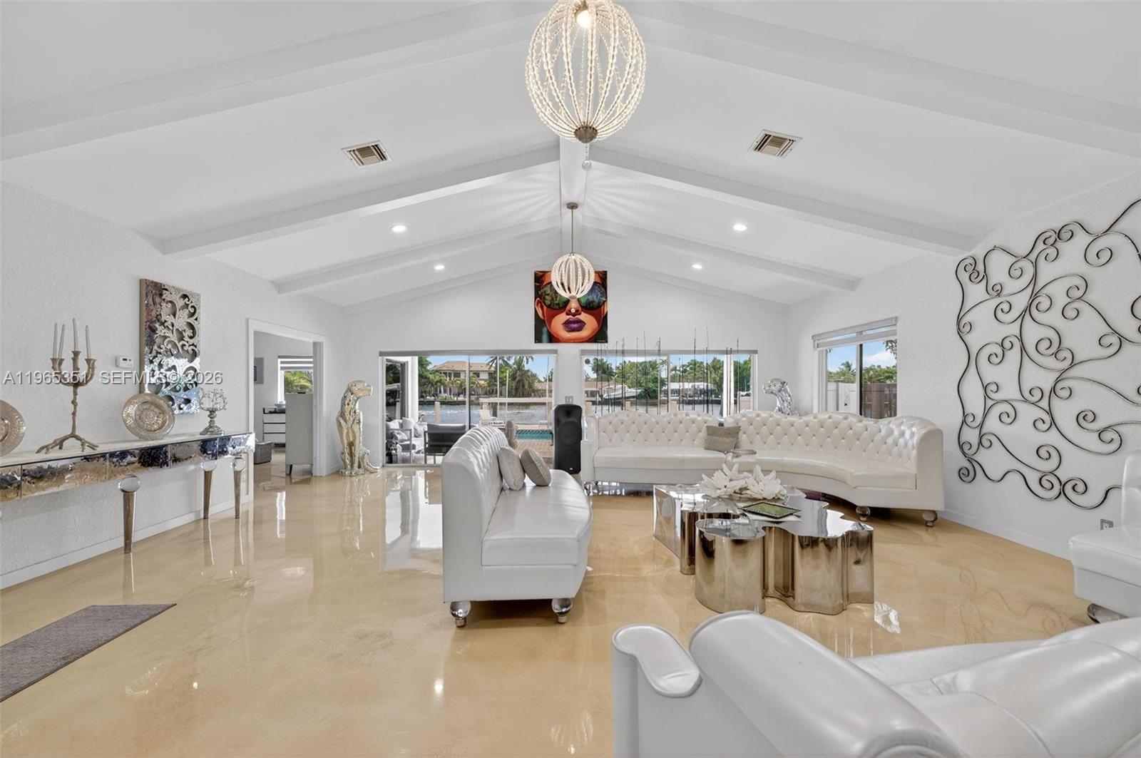 317 South Riverside Drive Pompano Beach, FL 33062 - Photo 15 of 25 a living room with furniture and a chandelier