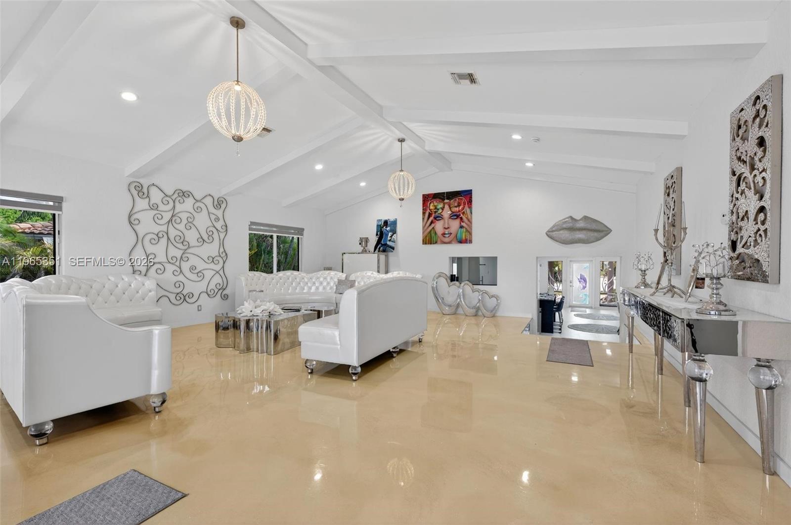 317 South Riverside Drive Pompano Beach, FL 33062 - Photo 16 of 25 a living room with furniture and a chandelier