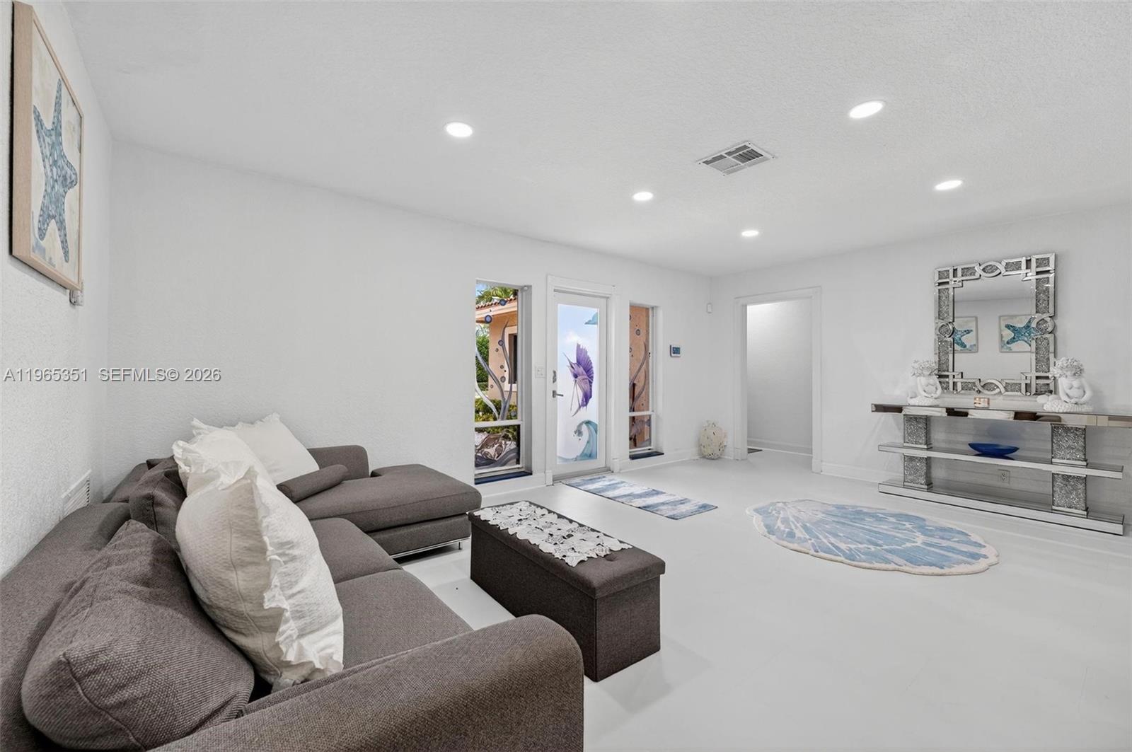 317 South Riverside Drive Pompano Beach, FL 33062 - Photo 20 of 25 a living room with furniture and a large window