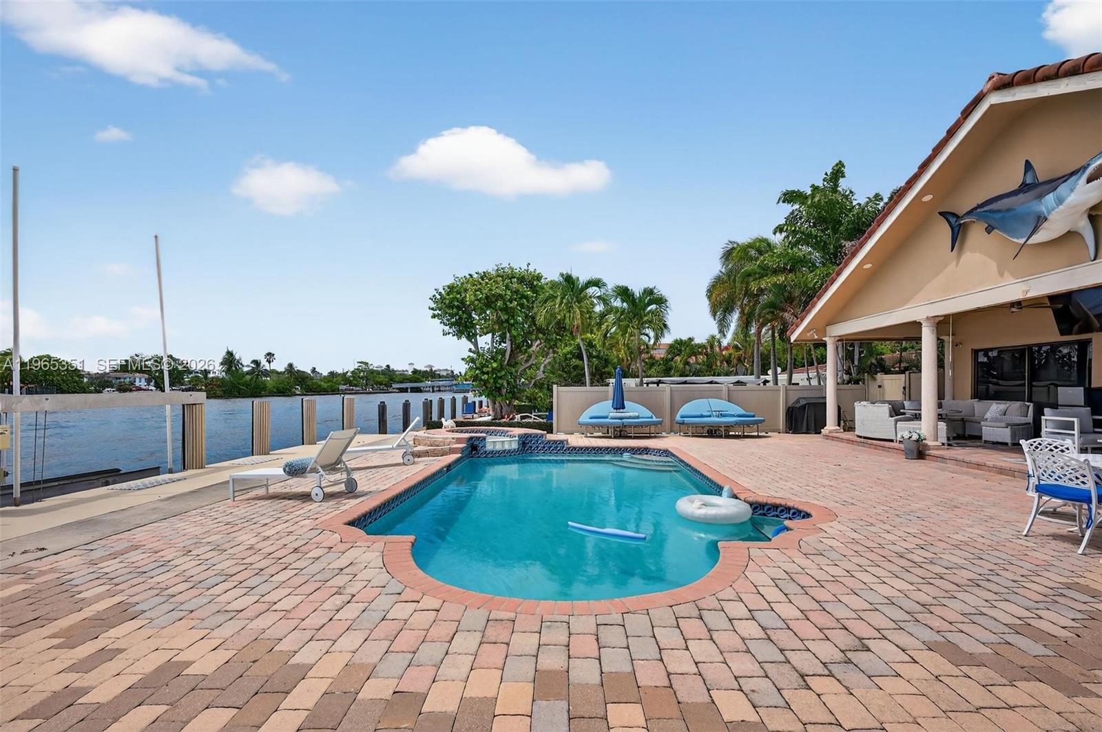 317 South Riverside Drive Pompano Beach, FL 33062 - Photo 21 of 25 a view of a swimming pool with a lounge chair