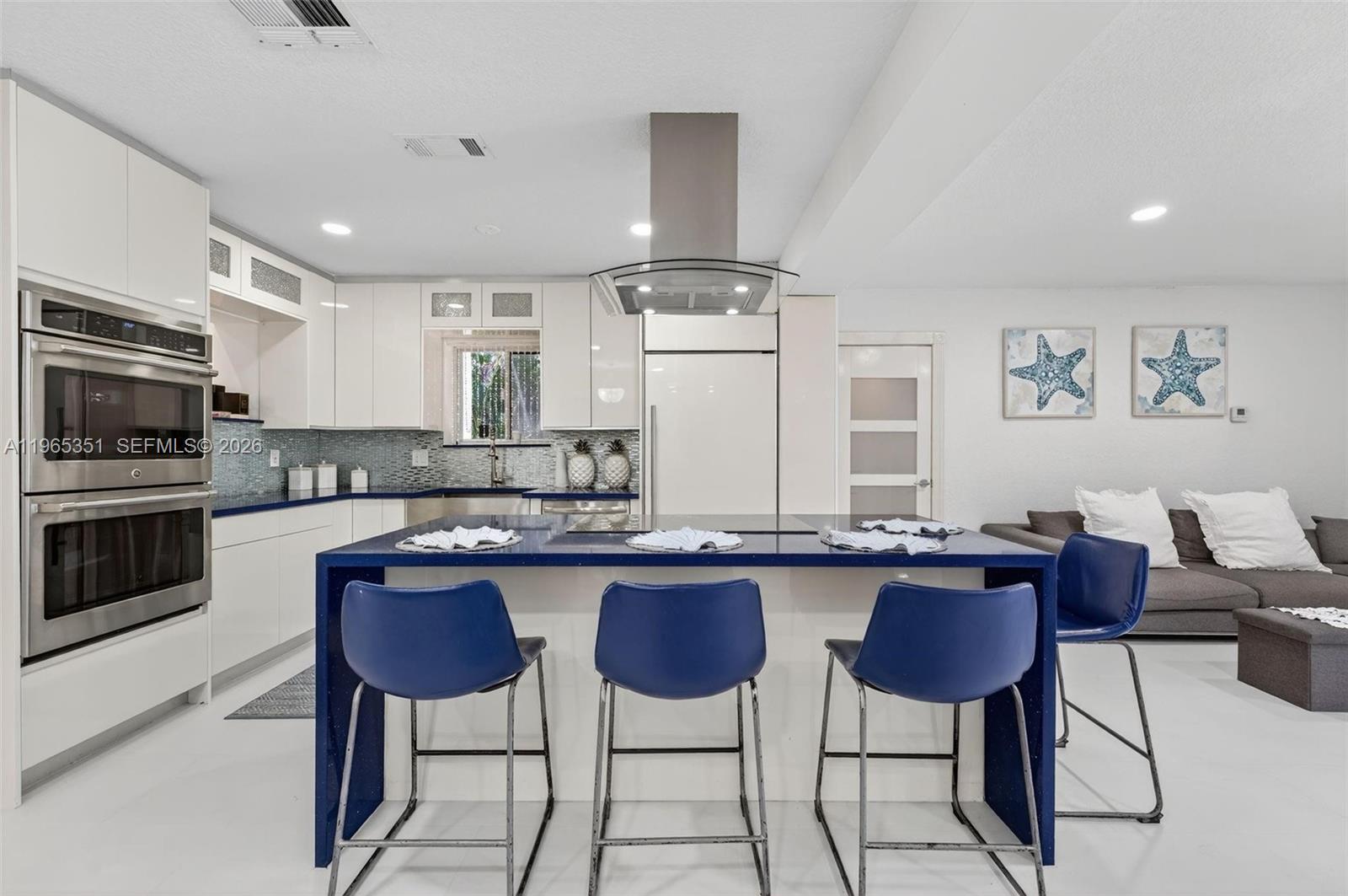 317 South Riverside Drive Pompano Beach, FL 33062 - Photo 25 of 25 a kitchen with stainless steel appliances granite countertop a stove a sink dishwasher a dining table and chairs