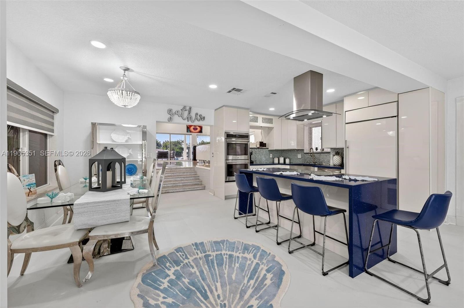 317 South Riverside Drive Pompano Beach, FL 33062 - Photo 9 of 25 a living room with furniture and kitchen view