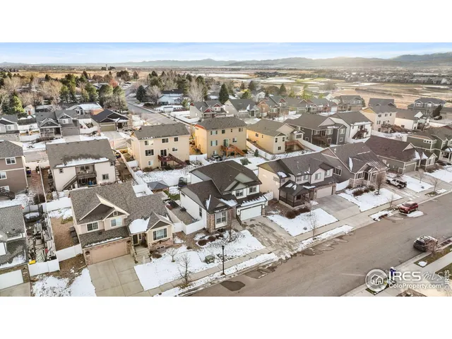 an aerial view of residential building with parking