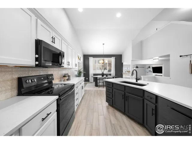 a kitchen with stainless steel appliances a stove sink microwave and cabinets