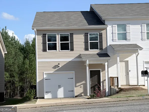 a front view of a house with a garage
