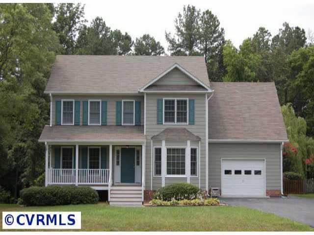 11905 Taplow Road Midlothian, VA 23112 - Photo 1 of 10 a view of a white house with a yard and large trees