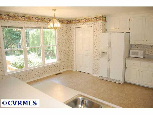 11905 Taplow Road Midlothian, VA 23112 - Photo 4 of 10 a view of a kitchen with an empty room and a window