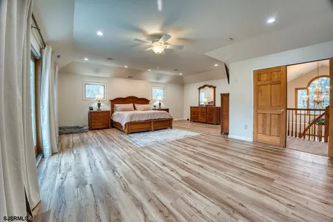 a spacious bathroom with a granite countertop tub sink a mirror a shower and a bathtub