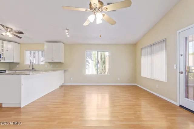 a view of a kitchen with a sink cabinets and wooden floor