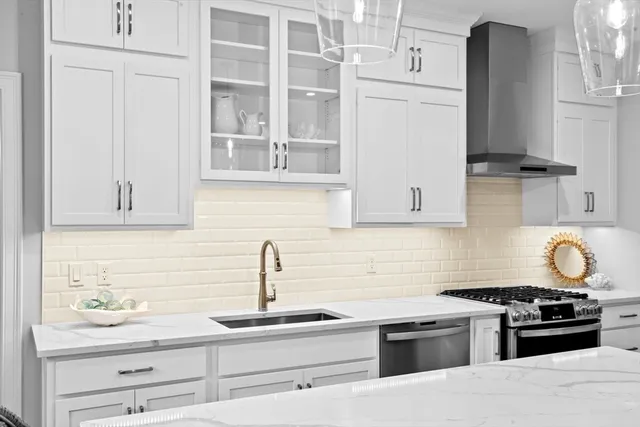 a kitchen with kitchen island a sink stove and refrigerator