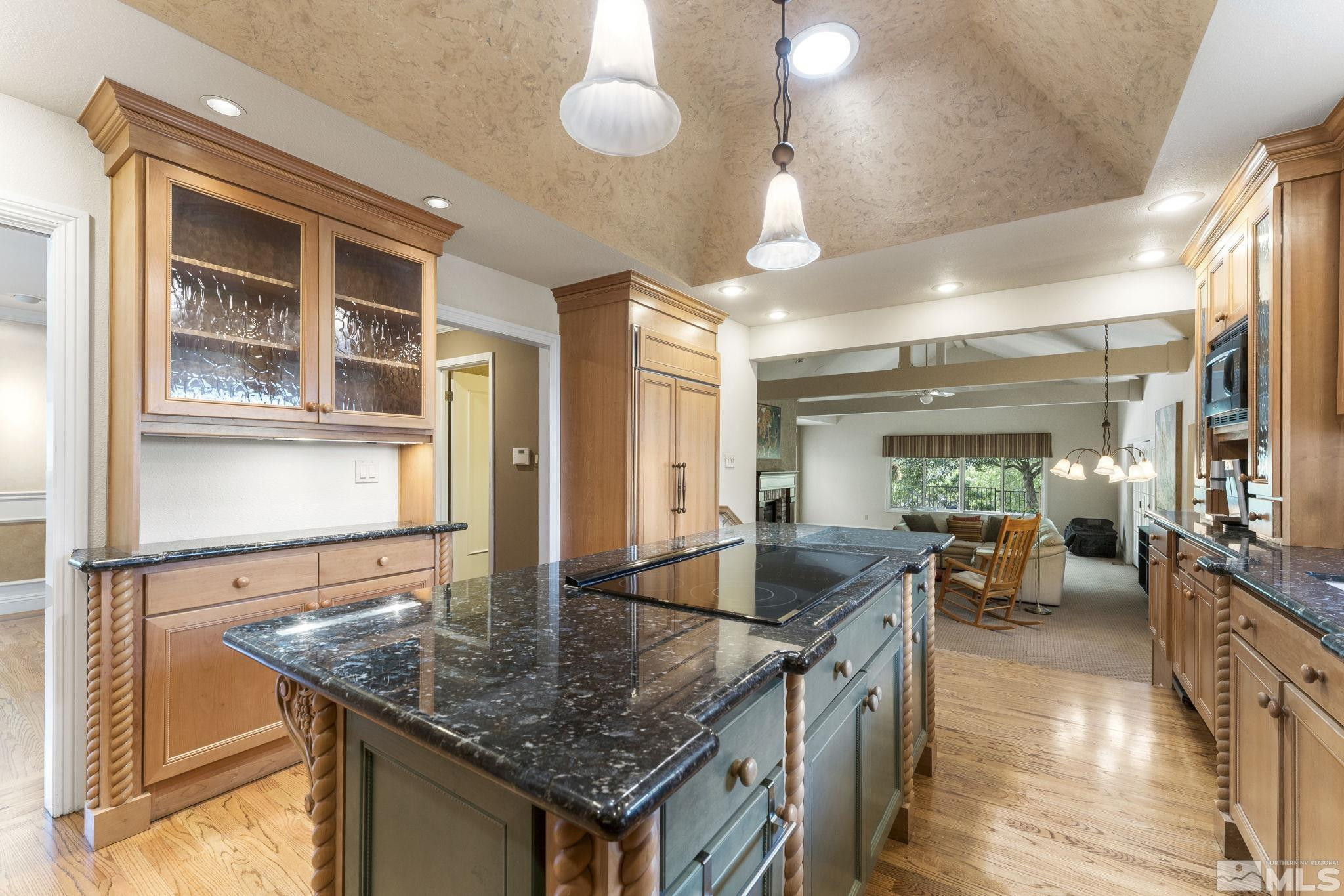 2650 Spinnaker Drive Reno, NV 89519 - Photo 11 of 40 a kitchen with stainless steel appliances granite countertop a sink a stove and a wooden cabinets