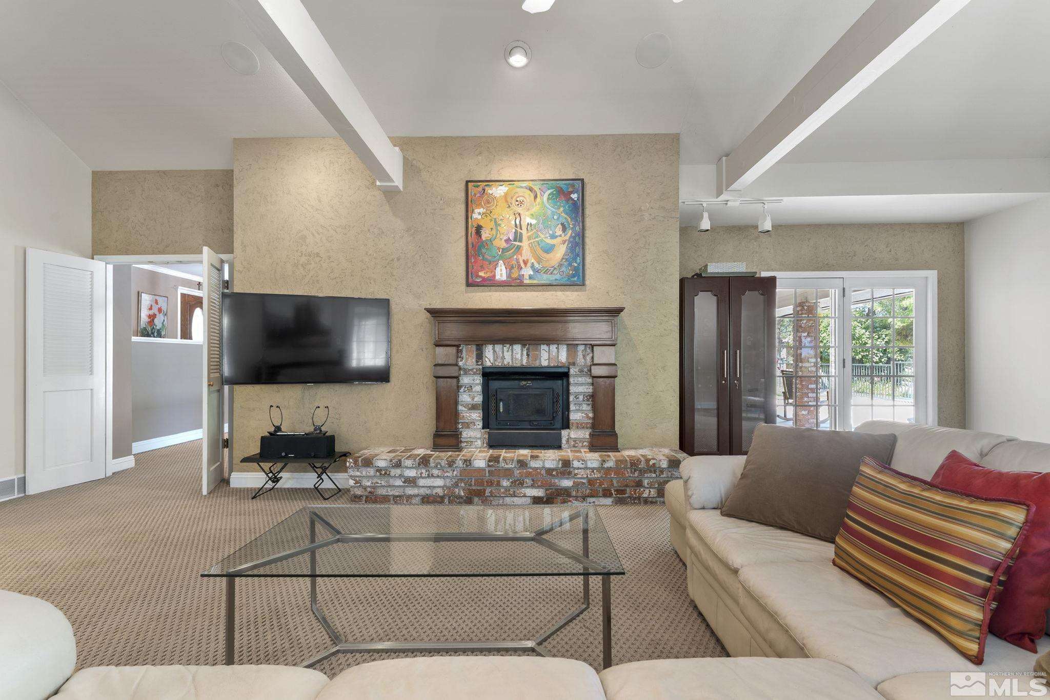 2650 Spinnaker Drive Reno, NV 89519 - Photo 13 of 40 a living room with furniture a flat screen tv and a fireplace