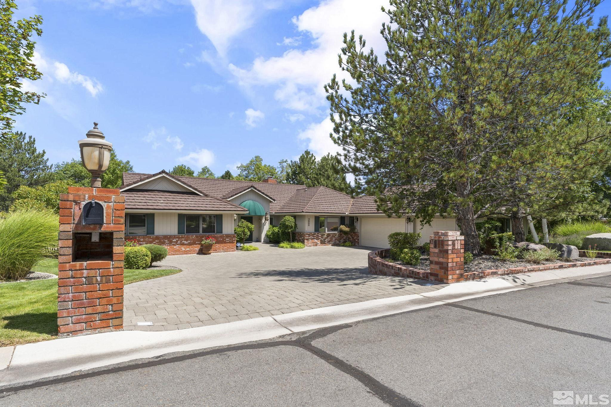 2650 Spinnaker Drive Reno, NV 89519 - Photo 2 of 40 a front view of a house with a yard and garage