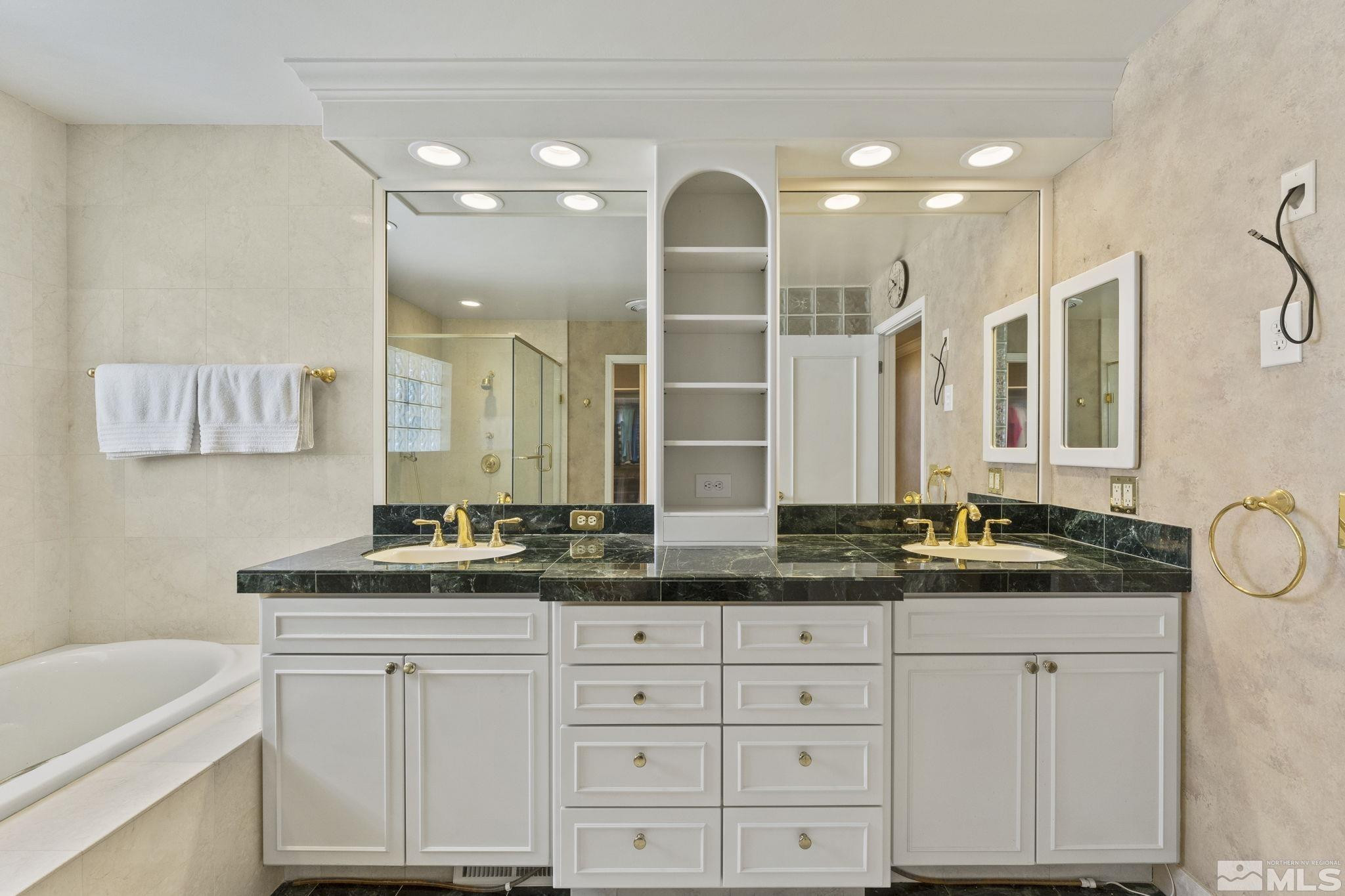 2650 Spinnaker Drive Reno, NV 89519 - Photo 21 of 40 a bathroom with a double vanity sink and a mirror