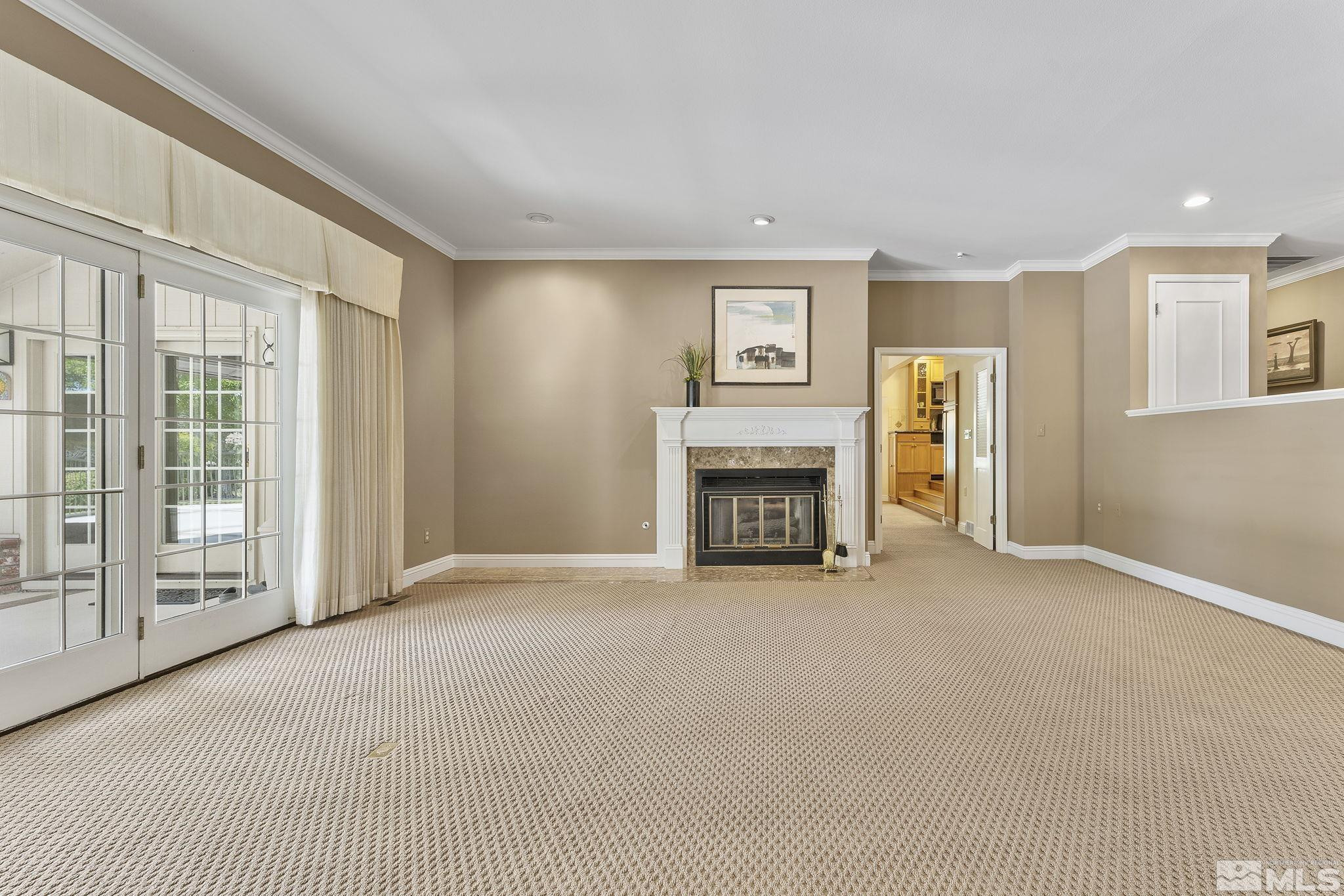 2650 Spinnaker Drive Reno, NV 89519 - Photo 6 of 40 a view of an empty room with a fireplace and a window