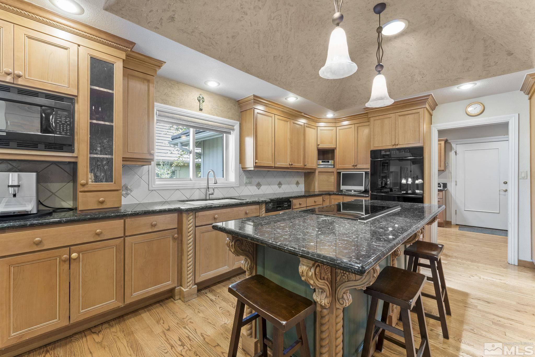 2650 Spinnaker Drive Reno, NV 89519 - Photo 8 of 40 a kitchen with a table chairs sink and cabinets