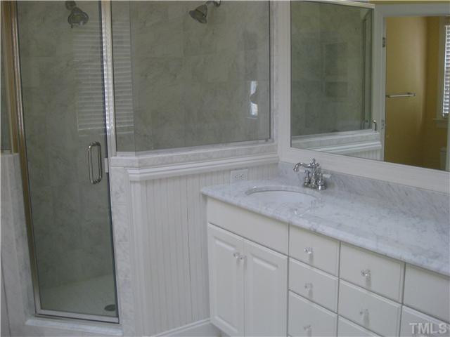 6104 Wilkinsburg Road Raleigh, NC 27612 - Photo 11 of 18 a bathroom with a granite countertop sink and shower
