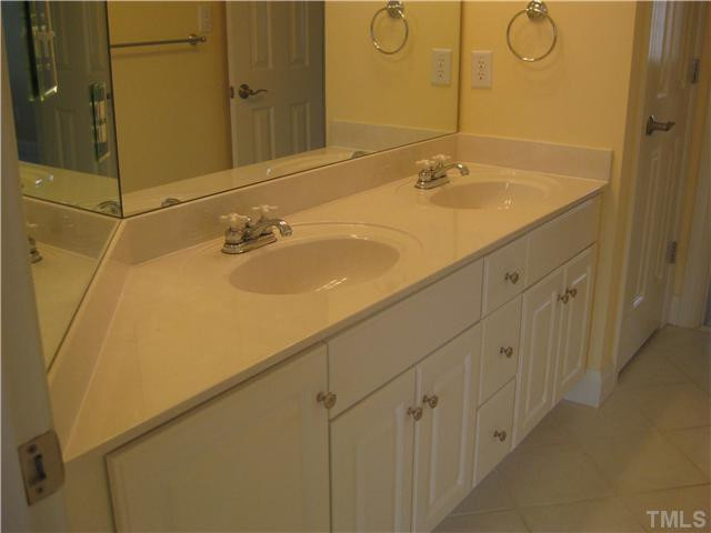 6104 Wilkinsburg Road Raleigh, NC 27612 - Photo 15 of 18 a bathroom with a sink and a mirror