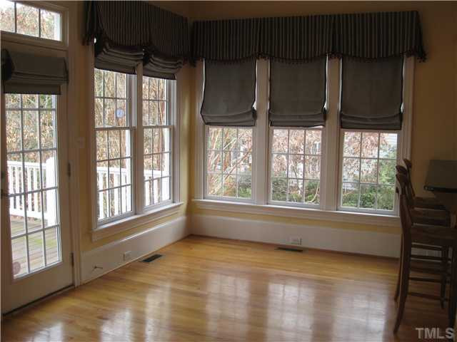 6104 Wilkinsburg Road Raleigh, NC 27612 - Photo 5 of 18 an empty room with wooden floor and windows