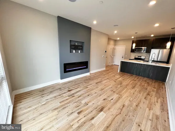 a large kitchen with kitchen island a sink stainless steel appliances and cabinets
