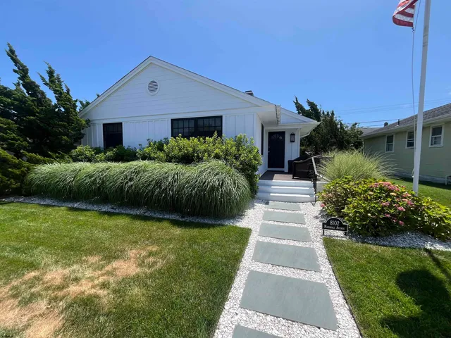 a front view of brick house with a yard