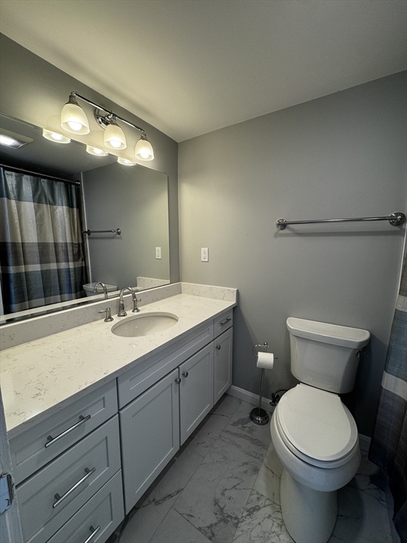 255 North Road, Unit 44 Chelmsford, MA 01824 - Photo 12 of 31 a bathroom with a toilet sink and mirror