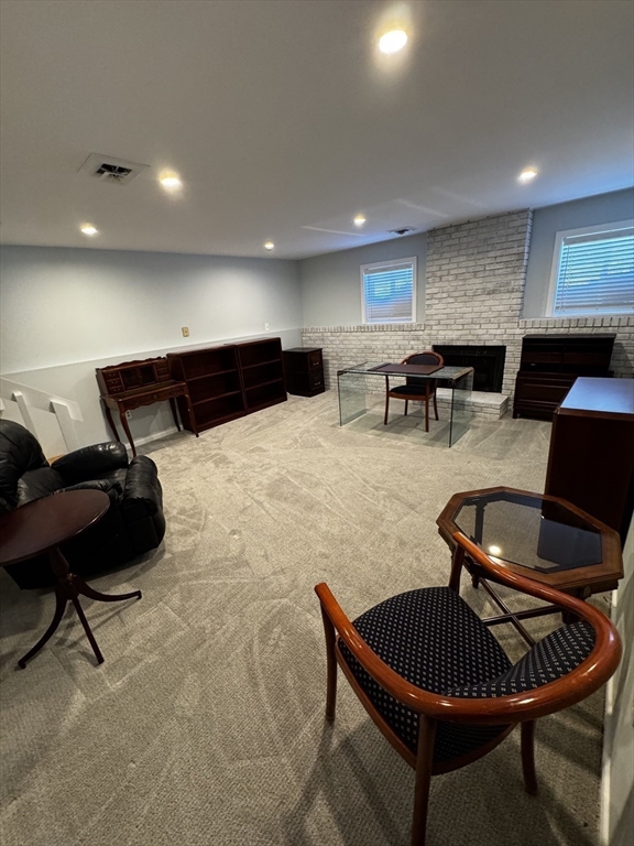 255 North Road, Unit 44 Chelmsford, MA 01824 - Photo 23 of 31 a living room with furniture a flat screen tv and kitchen view