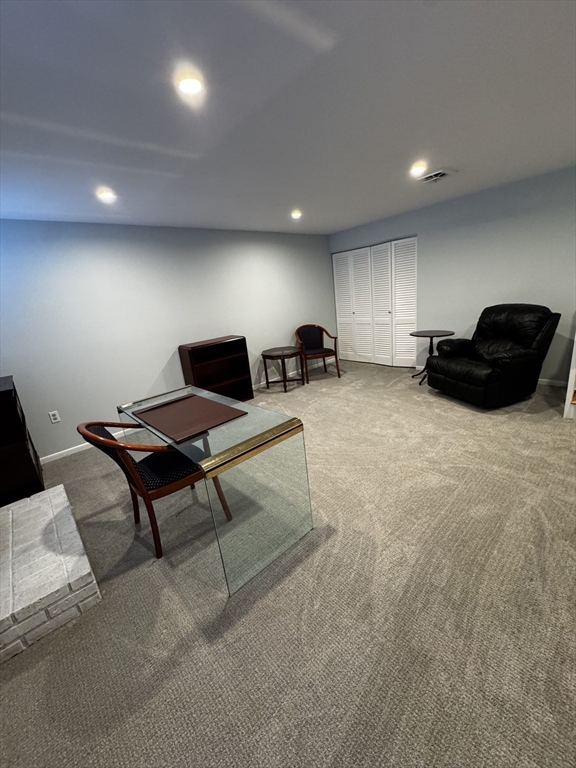 255 North Road, Unit 44 Chelmsford, MA 01824 - Photo 24 of 31 a living room with furniture a table and a flat screen tv