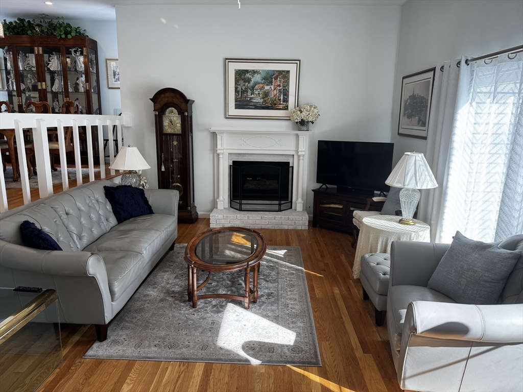 255 North Road, Unit 44 Chelmsford, MA 01824 - Photo 3 of 31 a living room with furniture a flat screen tv and a fireplace